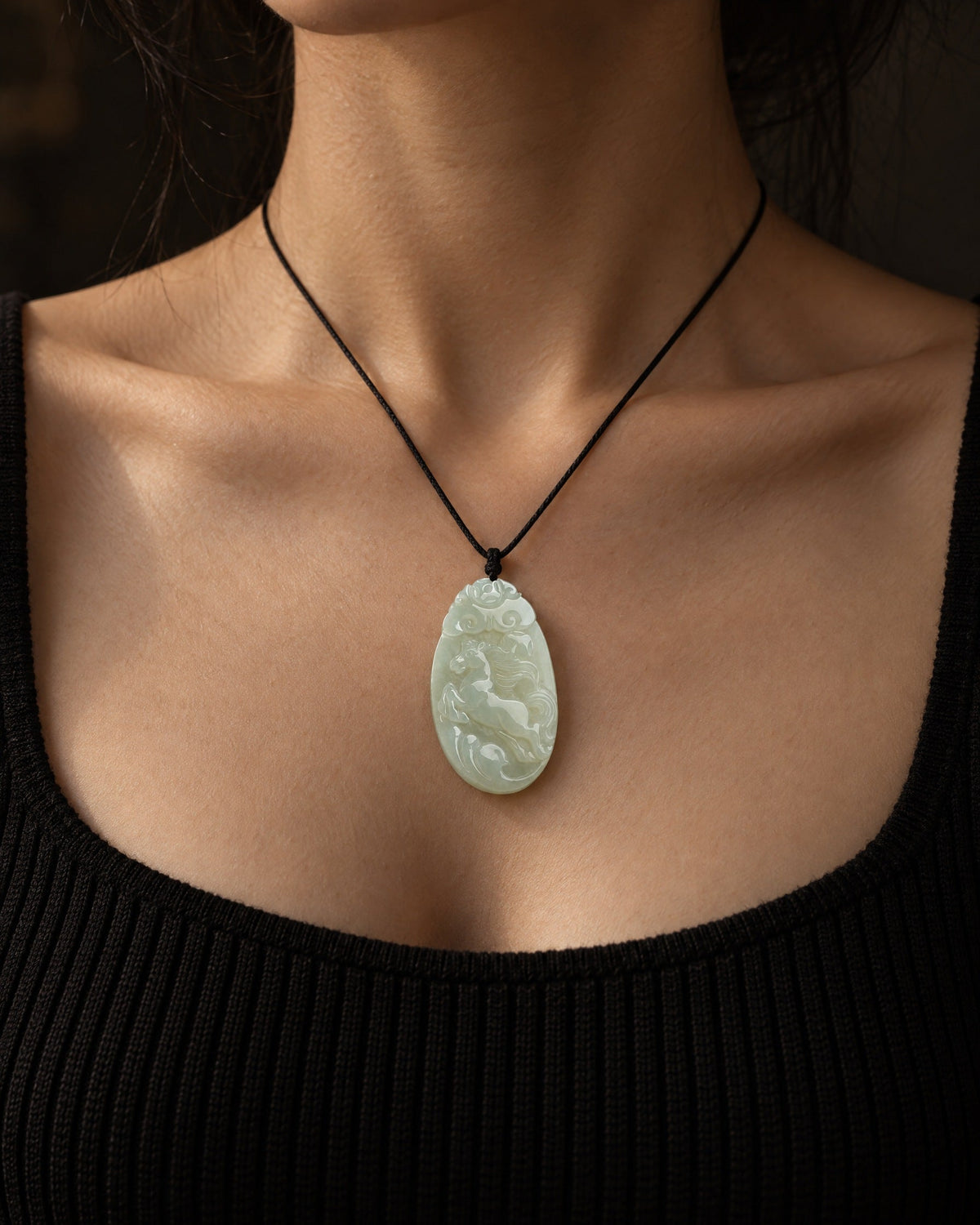 A jade horse pendant worn on a chain
